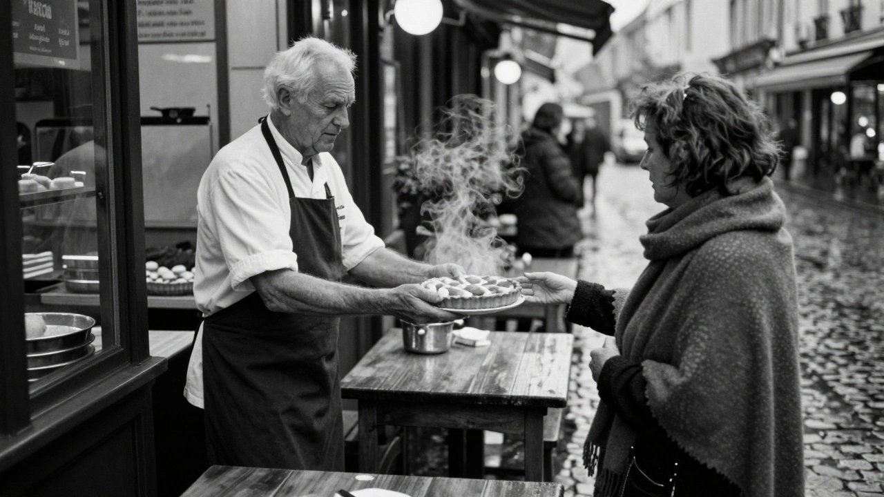 A baker hands a warm tart to a woman at a quiet bakery in Aix-en-Provence at dusk.